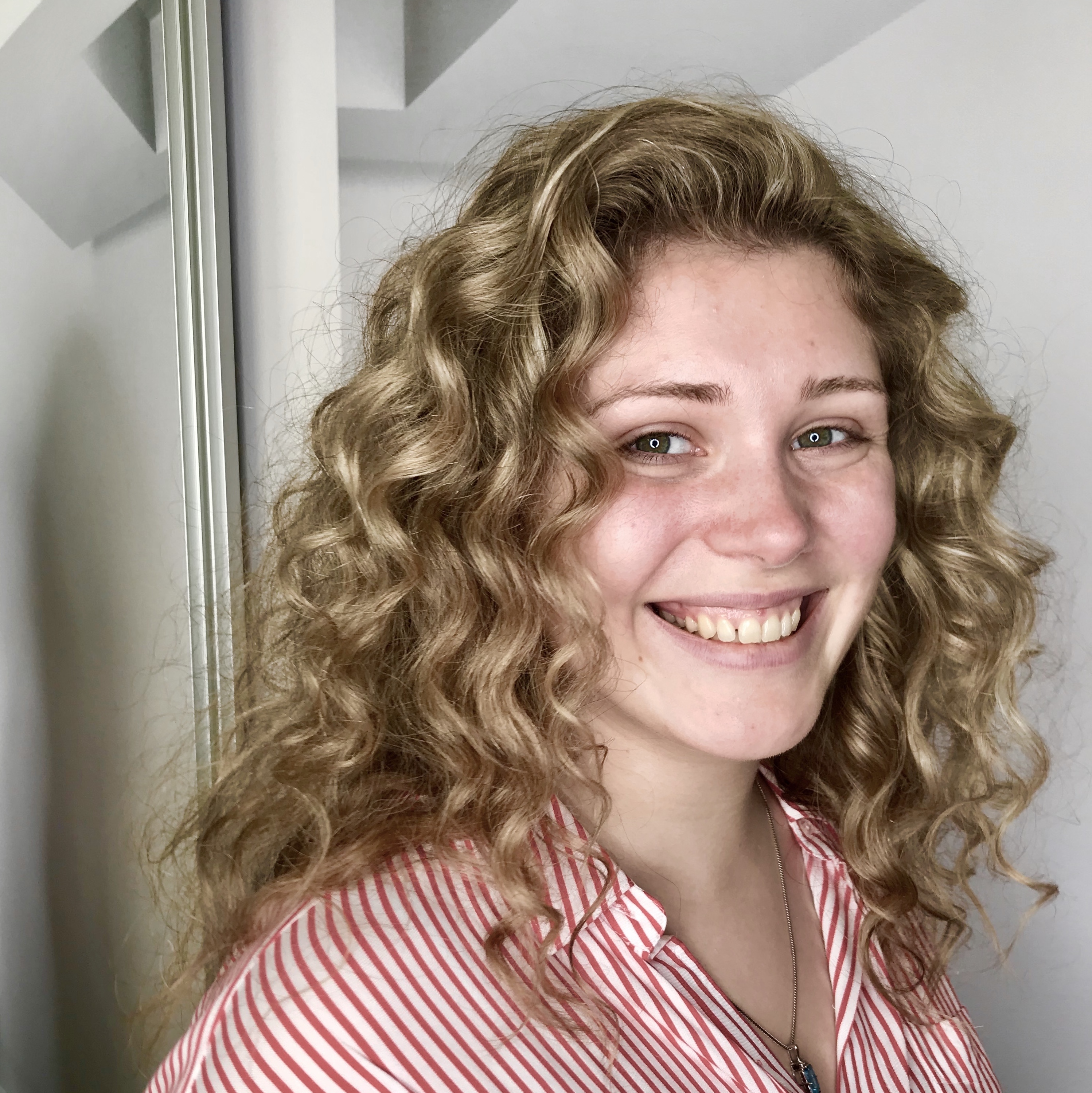 Woman in red and white striped shirt smiling